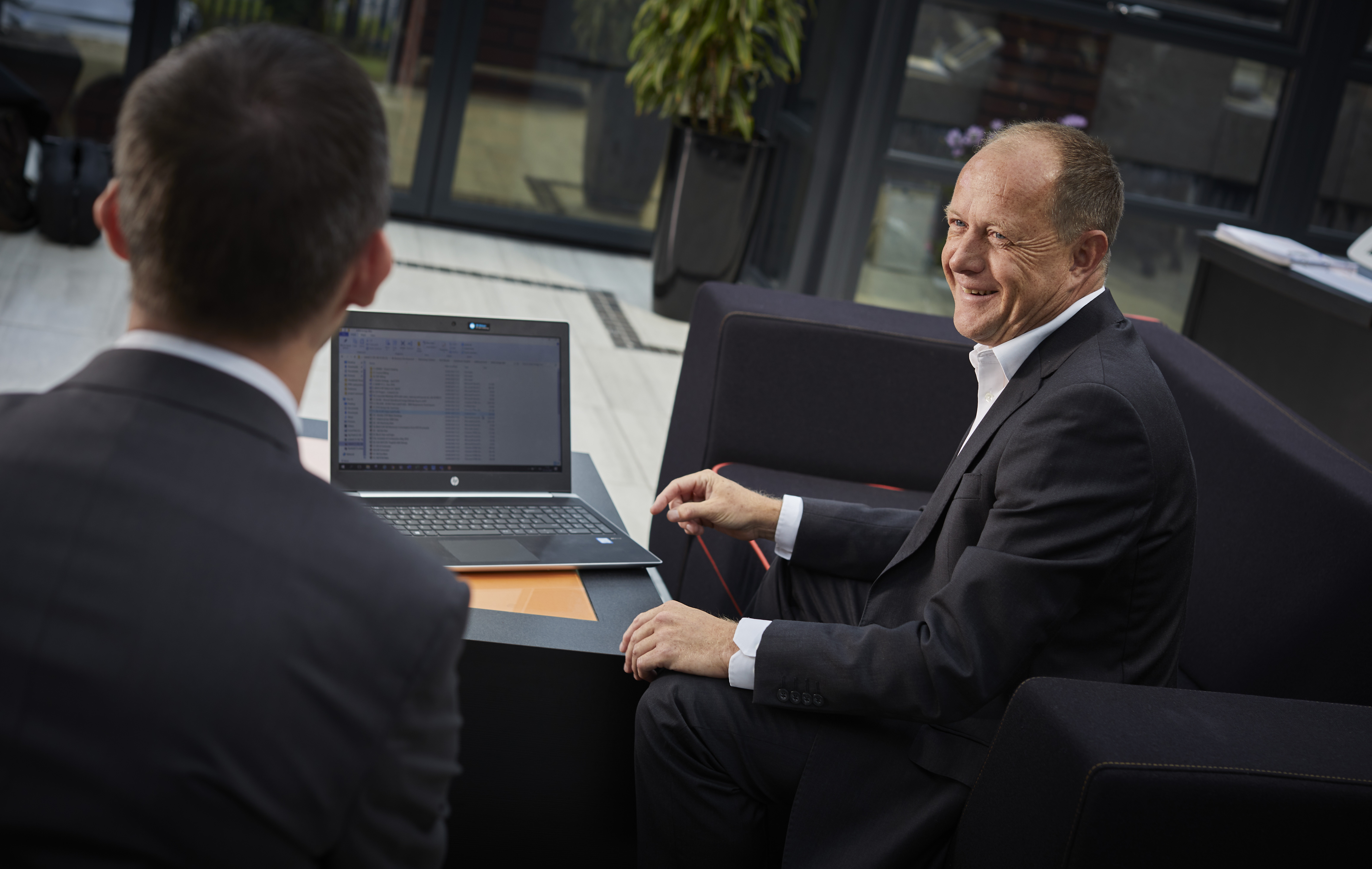 men chatting over a laptop